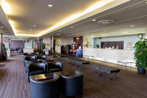 a lobby with a waiting room with chairs and a bar at Hotel Anesis Seto-Ohashi in Utazu
