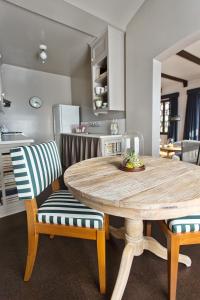 a kitchen with a wooden table and two chairs at Palihouse Santa Monica in Los Angeles