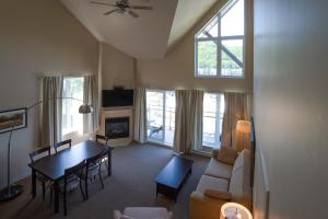 a living room with a table and a dining room at Condos Château-Bromont in Bromont