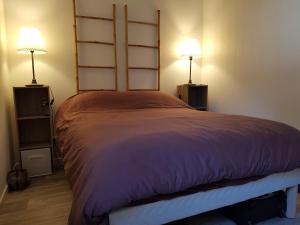 a bedroom with a large bed with two lamps at les marines de Tamaris in La Seyne-sur-Mer