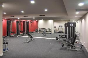 a gym with several treadmills and exercise machines at Atlantis Hotel Melbourne in Melbourne