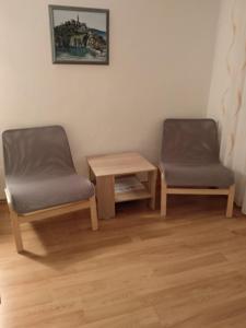 two chairs and a table in a room at Apartments Aleksandra in Crikvenica