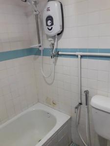 a bathroom with a shower and a bath tub at Mersing Merlin Inn in Mersing