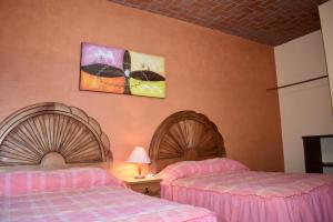 Ένα ή περισσότερα κρεβάτια σε δωμάτιο στο Posada Rincon Magico