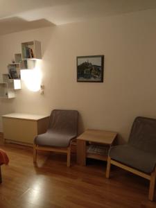 a waiting room with two chairs and a table at Apartments Aleksandra in Crikvenica
