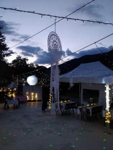 a tent with tables and chairs at night with lights at Les 2 Alpes in Puget-Théniers