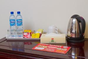 a table with bottles of water and a coffee maker at Lotus Hotel Masjid India in Kuala Lumpur