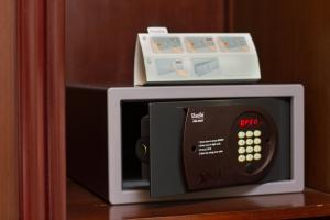 a microwave with a box on top of it at Lotus Hotel Masjid India in Kuala Lumpur
