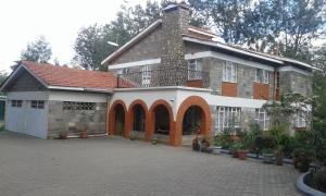 a large brick building with a balcony on top of it at Kepro Farm in Nairobi