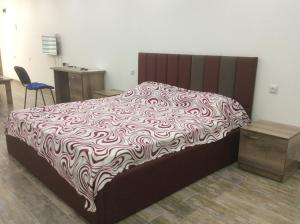 a bedroom with a bed with a brown and white blanket at Apartment on Saryan 24 in Yerevan
