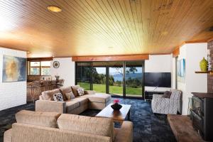 a living room with two couches and a tv at Magic Mountain at Smiths Lake in Smiths Lake