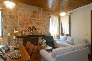 a living room with a stone wall at Nafplio Place in Nafplio