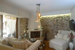 a living room with a couch and a fireplace at Bella's Rustic Suites in Nafplio