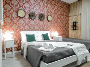 a bedroom with a bed and two mirrors on the wall at Magic Double in Rome