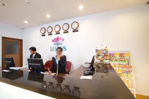 two people sitting at a desk in an office at Lotus Hotel Masjid India in Kuala Lumpur