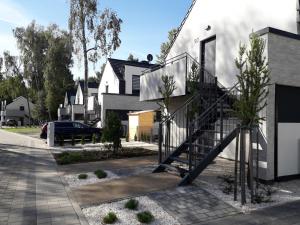 a house with a staircase on the side of it at Sea Suite Garden & Pines in Łukęcin