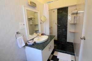 a bathroom with a sink and a mirror at Aashray Homestay in Varanasi +26 photos