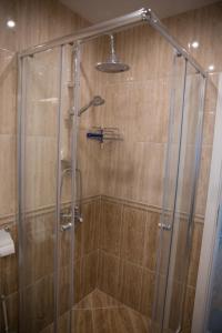 a shower with a glass door in a bathroom at Sonia Apartment in St. St. Constantine and Helena