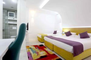 a hotel room with two beds and a bathroom at Hotel Boutique Libris in Sarajevo