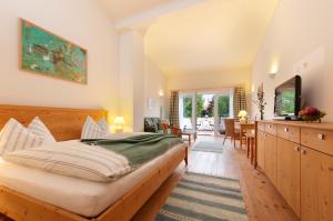 a bedroom with a bed and a dining room at Winzerhof Schindler in Mörbisch am See