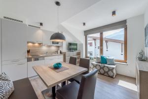 a kitchen and dining room with a wooden table and chairs at Appartement Cristallo in Sölden