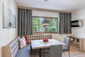 a living room with a couch and a table at Appartement Cristallo in Sölden