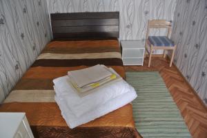 a bedroom with a bed with two towels on it at Narva Econom in Narva