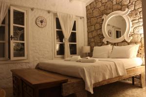 a bedroom with a large bed and a mirror at Alaçatı Ala Hotel - Special Category in Alacati