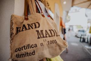 a hand madilla bag hanging on a wall at Das Hotel Stern 24h self-check-in in Sankt Gilgen