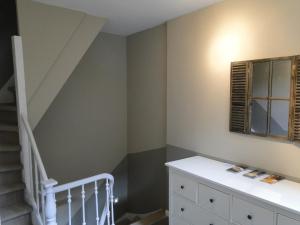 a room with a white wall and a black and white floor at Zucchero Apartment Brugge in Bruges