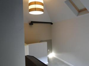 an empty room with a light on the ceiling at Zucchero Apartment Brugge in Bruges