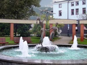 a statue of children playing in a fountain in a park at Hotel Slovan in Žilina +20 photos