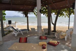 a patio with a view of the beach at Sunshine Beach Condotel in Na Jomtien