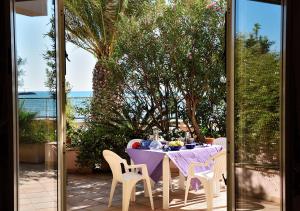 a table with a purple table cloth and chairs on a patio at Villa Metis in Realmonte