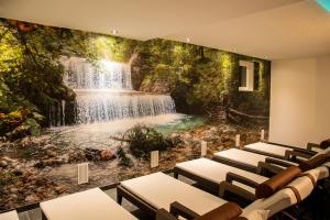 a conference room with a waterfall mural on the wall at Alpinium - inklusive SUPER SOMMER CARD in Fiss