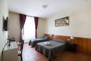 Posteľ alebo postele v izbe v ubytovaní Roma Enrico Guesthouse