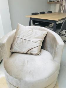 a pillow sitting on a chair in front of a table at LivingTheMoment in Ghent +57 photos