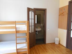 a bedroom with bunk beds and a bathroom with a sink at Panoramic Hostel in Khust