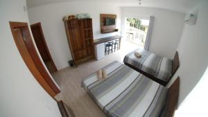 a view of a bedroom with a bunk bed at Embaú Mar - ecocasa Morada Canto Verde - Guarda do Embaú SC - Brasil in Guarda do Embaú