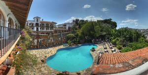 an aerial view of a swimming pool in front of a building at Posada de la Mision, Hotel Museo y Jardin in Taxco de Alarcón