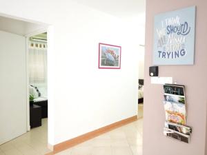 a room with a white wall and a refrigerator at A Ted House @ Damansara Perdana in Petaling Jaya