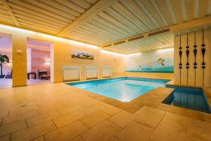 a pool in a house with a swimming pool at Hotel Dr Otto Murr B&B in Sankt Anton am Arlberg