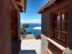 a view from a house looking out at the ocean at Wiñay Inti Lodge in Comunidad Yumani
