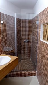 a bathroom with a shower and a sink at WW Hostel & Suites in Coimbra