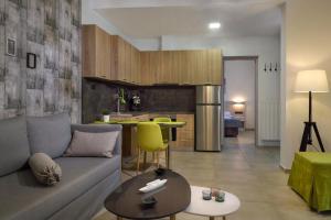a living room with a couch and a kitchen at Νautilus luxury apartments in Ierissos +20 photos