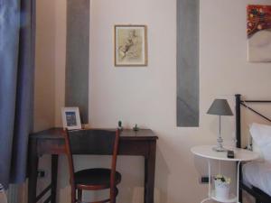 
a room with a bed, desk, chair and a computer at Bargello Guest House in Florence
