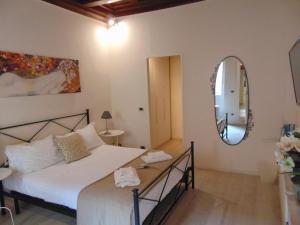 
a bedroom with a bed and a mirror at Bargello Guest House in Florence
