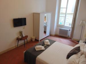 1 dormitorio con 1 cama con 2 toallas en Michelangelo's Relais, en Florencia