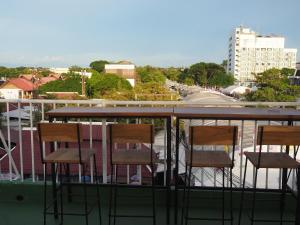 a group of chairs sitting on top of a balcony at Boonnark Bed Night Bazaar no car parking in Chiang Mai