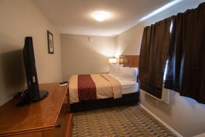 Ένα ή περισσότερα κρεβάτια σε δωμάτιο στο The Crow Peak Lodge